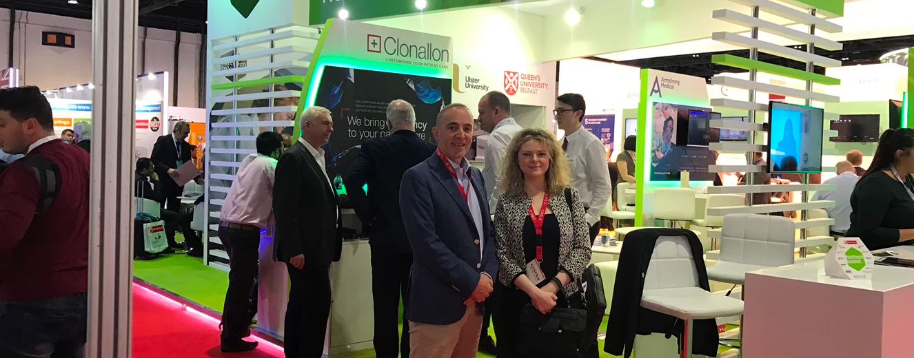 Team Lowe members pose in front of a display at Arab Health 2018, featuring green accents.