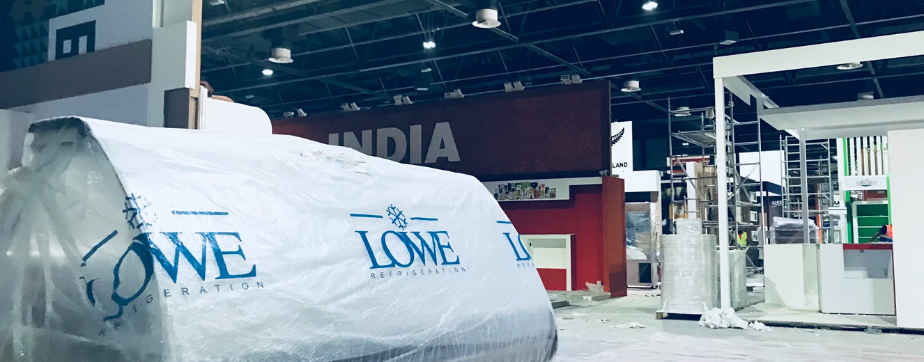 Lowe branding on a white cover, with a red "INDIA" sign in the background at Gulfood 2018.