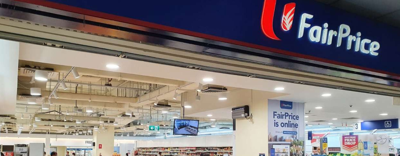Lowe Rental and FairPrice signage above a bright, modern retail space with refrigeration units visible.