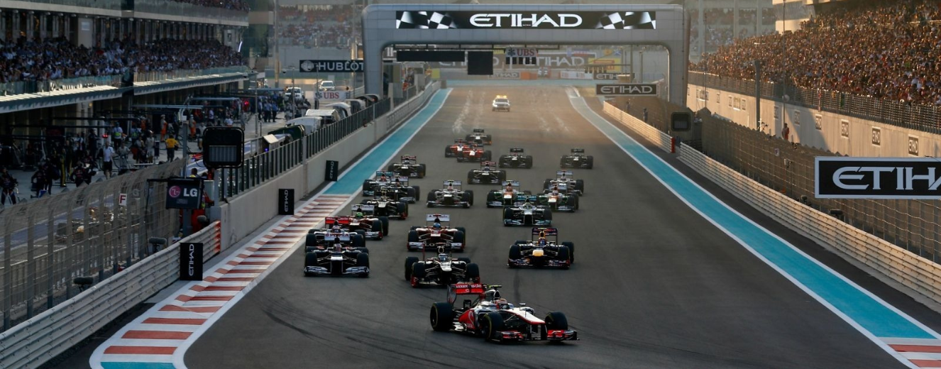 Formula 1 cars racing on a circuit, with a blue track and the Etihad sign in the background.