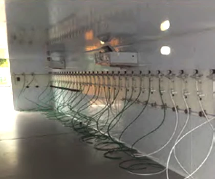 Interior of a modular cold room featuring grey walls and multiple white pipes along the floor.