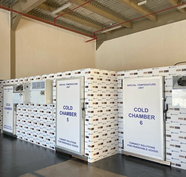 Modular cold rooms with white exteriors, labelled "COLD CHAMBER 5," in a spacious interior.