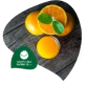Fresh oranges and orange slices on a dark wooden surface, with a green logo in the corner.