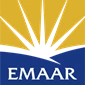 Emaar logo featuring a yellow sunburst over a blue background with the word "EMAAR" prominently displayed.
