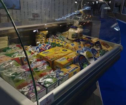 Colourful assortment of packaged food items displayed in a glass-fronted freezer unit.