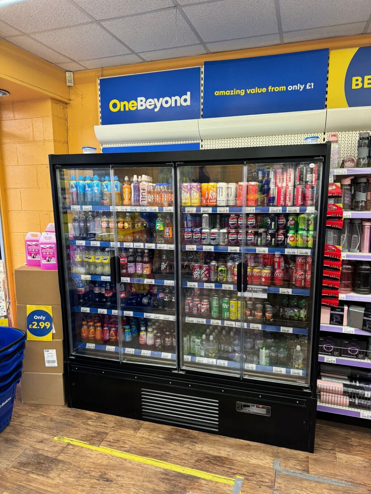 Fridge display filled with colourful drinks, featuring the One Beyond branding above.
