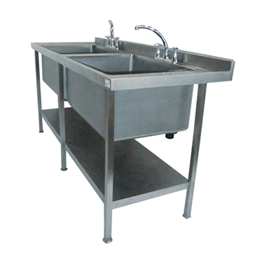 Stainless steel double sink with two taps and a lower shelf for storage.