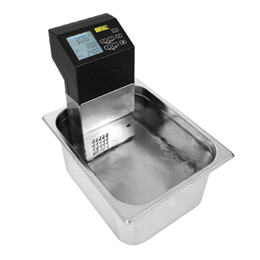 Sous vide cooker with a black control panel, placed in a stainless steel water bath.