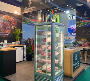 Showcase of fresh fish displayed in a glass refrigerator, set against a vibrant exhibition backdrop.