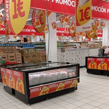 Promotional display with red and yellow signage, featuring products priced at €1 in a retail setting.