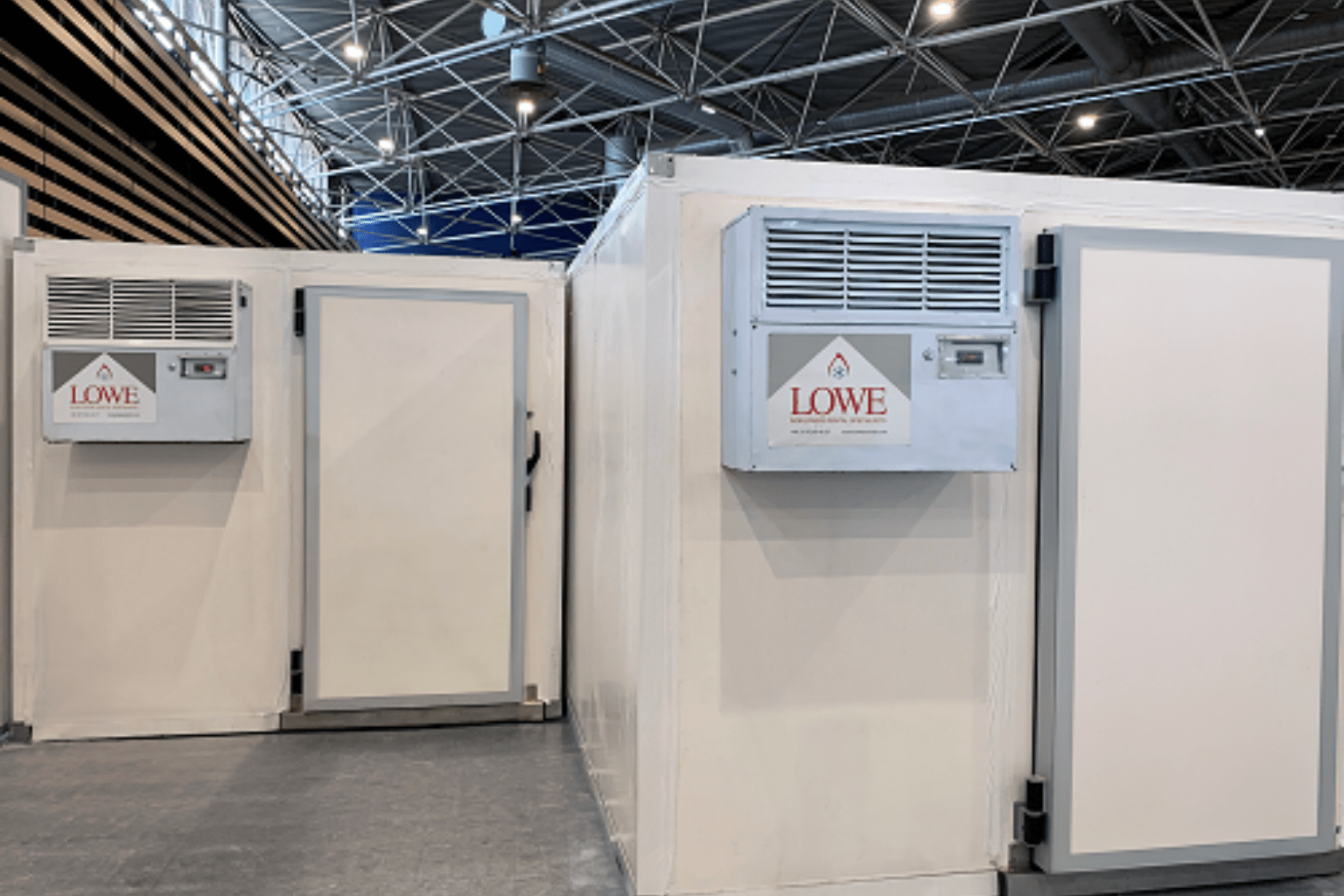 White cold storage units with Lowe Rental branding, set against a modern industrial background.