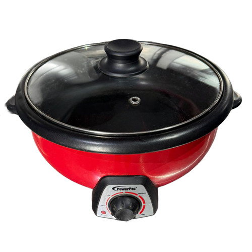 Red electric fry pan with a black lid and control knob, designed for versatile cooking.