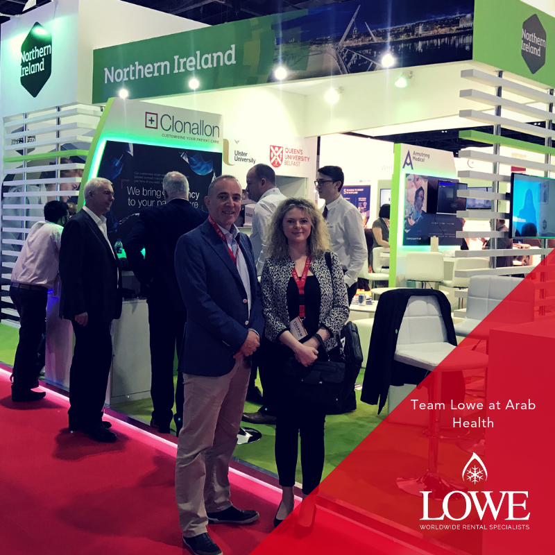 Team Lowe stands in front of a vibrant green and white exhibition stand at Arab Health 2018.