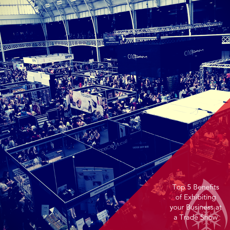 A bustling trade show with numerous black exhibition stands and a vibrant red accent in the foreground.