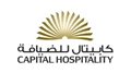 Capital Hospitality logo featuring a golden sunburst design and Arabic text on a white background.