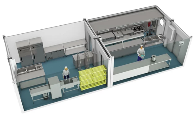 Temporary kitchen layout featuring stainless steel equipment and blue flooring, with two workers in yellow helmets.