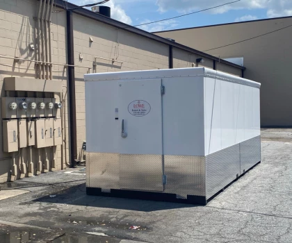 Large white storage container with a metallic base, situated on a concrete surface.