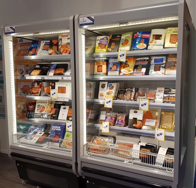 Two glass-fronted freezers filled with various frozen food products, predominantly in bright packaging.